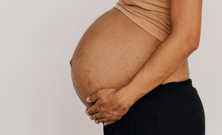 How is the baby positioned in the womb?